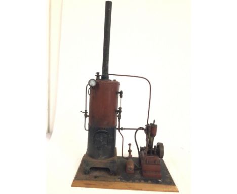 A bespoke static steam engine mounted on a wooden plinth.