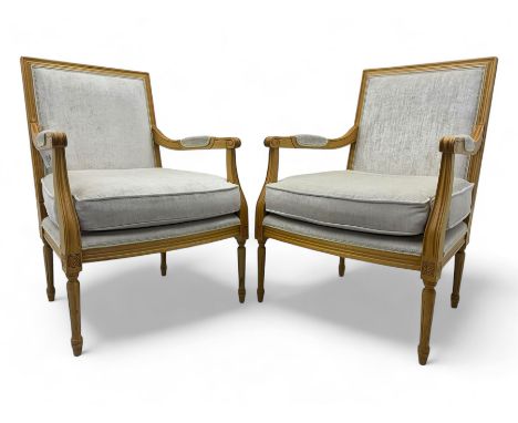 Pair of mid-20th century beechwood fauteuil armchairs, upholstered backrest and seat in beige velvet fabric, padded armrests 