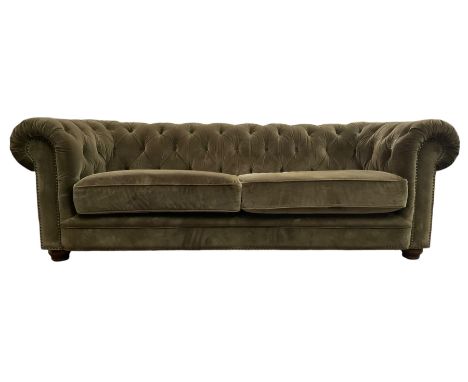 Contemporary Chesterfield design four-seater sofa, upholstered in olive green velvet, deep button-tufted back and arms, rolle