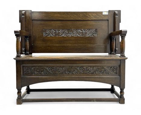 Early 20th century oak monk's bench, hinged and sliding panelled back carved with foliate S-scrolls, hinged box seat over car