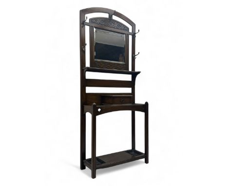 Early 20th century oak hall stand, arched top over foliate carved bands and bevelled mirror plate, fitted with small drawer a