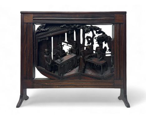 Hardwood firescreen, moulded frame enclosing rectangular panel carved in high relief depicting Chinese artisans, on splayed f