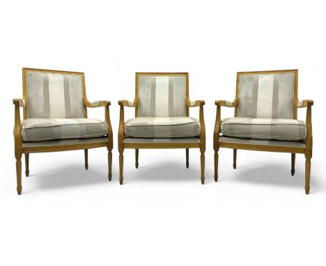 Three mid-20th century beechwood fauteuil armchairs, upholstered backrest and seat in cream stripe fabric, padded armrests wi