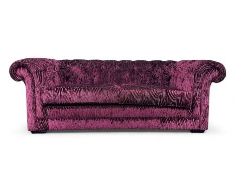 Contemporary Chesterfield design two-seat sofa, upholstered in fuchsia crushed velvet with a ribbed and tufted design, the ro