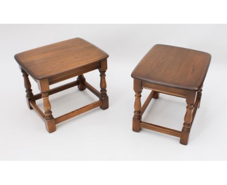 A pair of Ercol Windsor elm drinks or occasional tables - the rounded rectangular tops on baluster turned supports with block