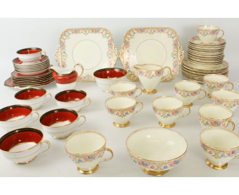 A Foley China tea service - 1920s-30s, painted with ornate gilt borders with polychrome flowers, comprising a cream jug, suga