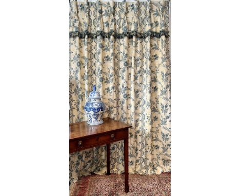 A pair of handmade curtains in medium-weight printed cotton fabric, pale yellow and cream floral background with a vertical t