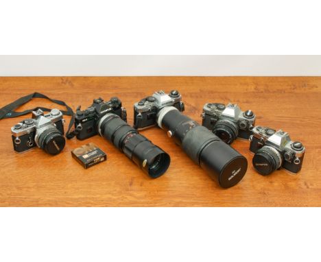 A large collection of Olympus OM Series cameras, lenses and accessories - including an OM2 camera with Auto Panagor Tele Zoom