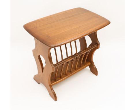 An Ercol Windsor Canterbury or magazine rack table - original maker's labels to underside (LWH 55 x 36 x 50 cm); together wit