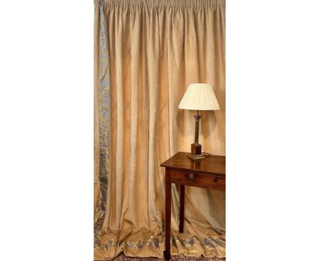 A pair of pale caramel-coloured, cotton velvet curtains with gold and pale lavender damask border to bottom and leading edge,