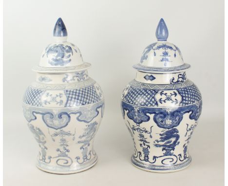 A matched pair of Chinese blue and white porcelain covered baluster vases - painted with dragons, phoenix and auspicious obje