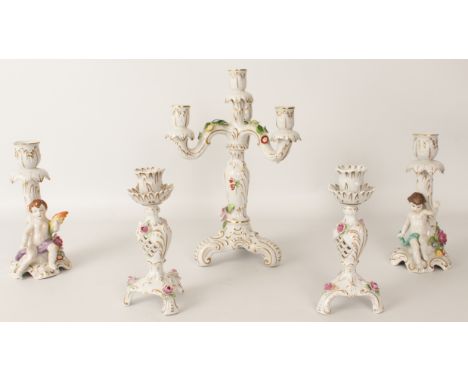 A three-piece porcelain candelabra and candlestick garniture - late 20th century, the four-light candelabra decorated with fl