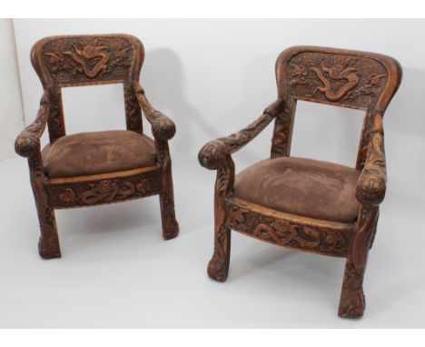 A pair of Anglo-Chinese carved hardwood spoon back armchairs - c.1900, the balloon backs with open rectangular window opening