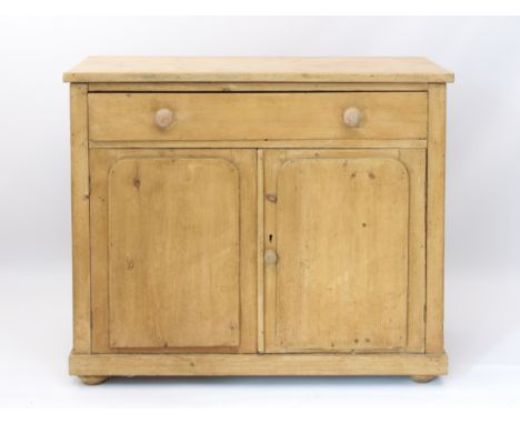 A Victorian stripped pine buffet or side cabinet - with one long drawer over a pair of cupboard doors with relief arched pane