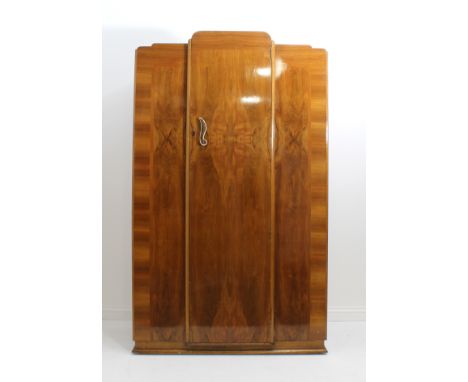 An Art Deco walnut cloud-style three-piece bedroom furniture suite - comprising double and single wardrobes and a matching dr