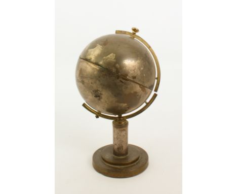 A 1950s retro brass and plated globe cigarette dispenser - the globe on a circular stand, the oceans and seas with a silvered