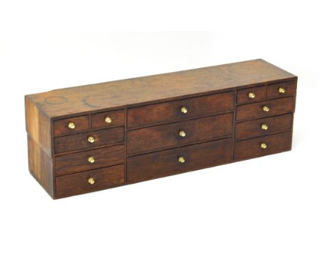 A late 19th / early 20th century oak workman's tool chest - rectangular form, with a bank of three central drawers flanked by