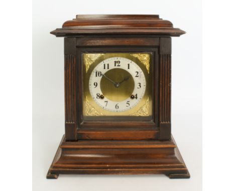 A 1920s walnut cased chiming mantel clock - the eight day, half hour striking movement fronted by a square brass dial with si