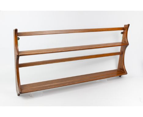 An Ercol Windsor range beech and elm hanging plate rack - with original maker's label, 96.5 cm long.