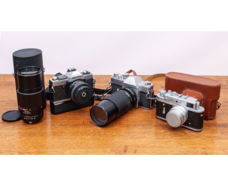 A small collection of 35mm SLR film cameras and lenses - including a Minolta XG-1 with MD f/2 50mm lens and Auto-Winder; a Ma