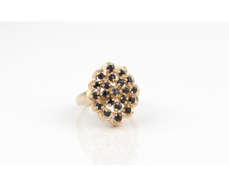 A 9ct yellow gold and sapphire cluster ring - Birmingham hallmarked, size N/O (gross weight 5.8g).