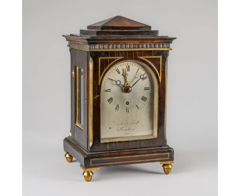 A LATE REGENCY EBONISED AND BRASS LINE-INLAID CHAMFER TOP SMALL MANTEL TIMEPIECE WITH ALARM AND LATER BRACKETBy Ogston and Be