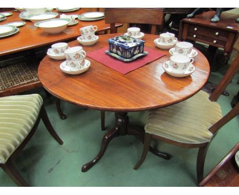 A George III flame mahogany circular tilt top wine table on vase shaped turned column and pad foot tripod base,  83cm diamete