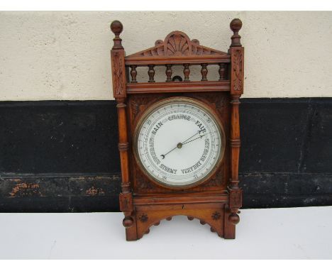 A late Victorian wall hanging barometer with carved case spindle detail, 56cm x 30cm 