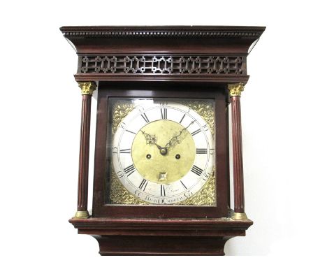 An 18th Century flame mahogany longcase clock with blind fretwork detail to hood. 12" square brass dial with Roman/Arabic sil