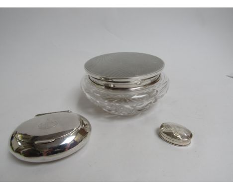 A silver oval snuff box, dented (Birmingham 1909), a cut glass dressing table pot with silver lid and a modern silver pill po