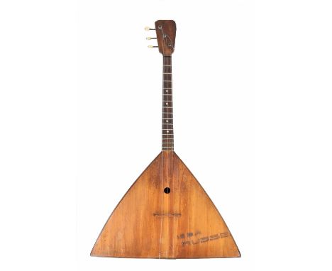 Soprano balalaika, circa 1960, of standard triangular form, the back comprising seven ribs probably birch, the table with a s