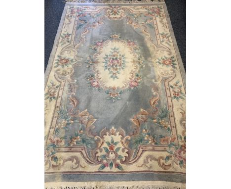 WASHED WOOLLEN CHINESE CARPET - light blue and cream ground with central floral cartouche and single floral border with tasse