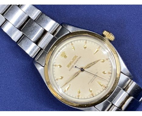 ROLEX OYSTER PERPETUAL STAINLESS STEEL GENT'S BRACELET WRISTWATCH - No 976511 circa 1960, gold bezel and crown winder, champa