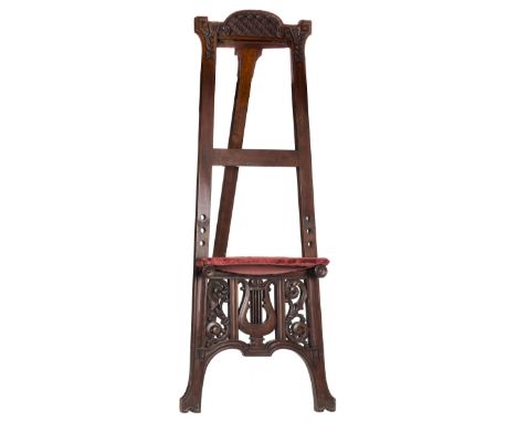 * Artist's Easel. A late Victorian mahogany artist's easel, of tapered form, carved with geometric flowers heads and sprigs, 