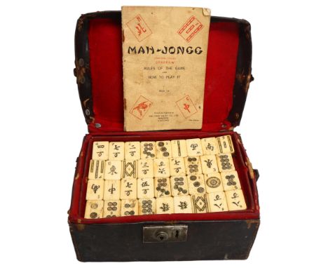 A Chinese Mahjong set, bone and bamboo, in original leather case 