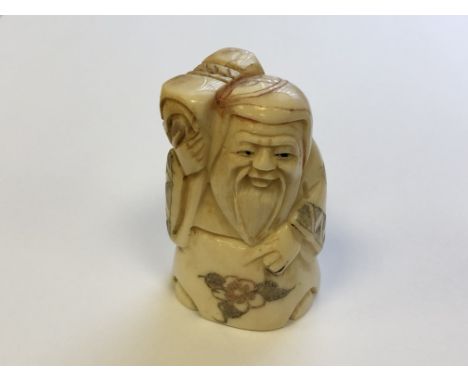 A Japanese carved bone netsuke - village elder carrying wares on his shoulder 