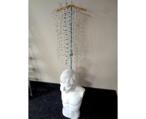 A wire mannequin on stand together with a shop mannequin torso of a man   