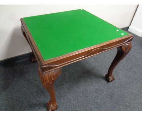 An Edwardian card table fitted with four card drawers on claw and ball feet 