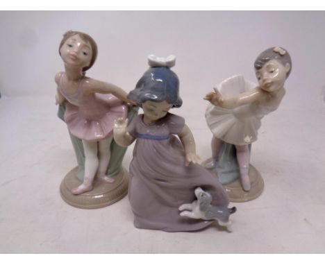 Two Nao figures, Ballerinas, together with a further Nao figure, Girl with puppy  