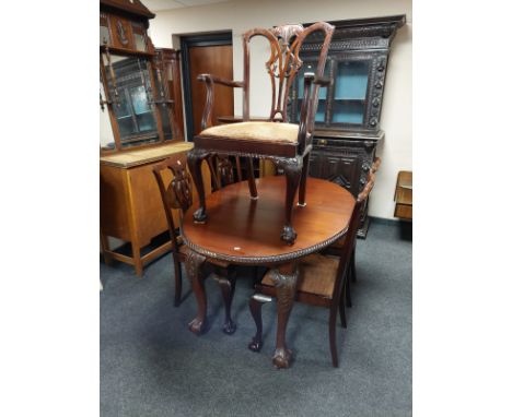 A mahogany extending oval dining table on claw and ball feet, length 150 cm, together with a set of five Chippendale style di
