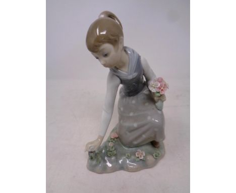 A Lladro figure, Girl picking flowers, No. 1172  