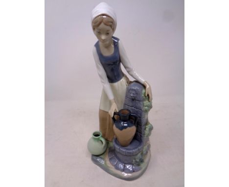 A Nao figure, girl at water fountain  