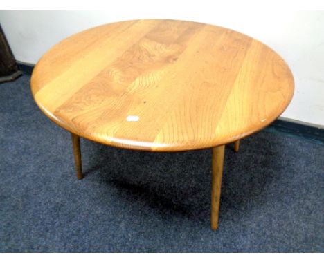 An Ercol elm coffee table on later legs