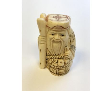 A Japanese carved bone netsuke - village elder with basket at his feet  