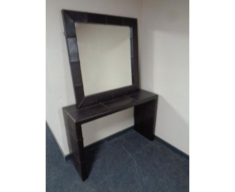 A contemporary brown leather console table with matching mirror  