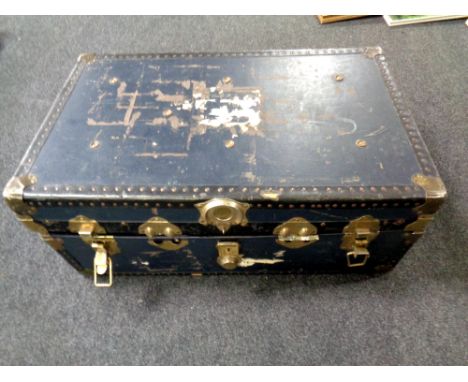An early 20th century metal bound trunk containing assorted lady's clothing, pair of Hawkridge wellies (new)  