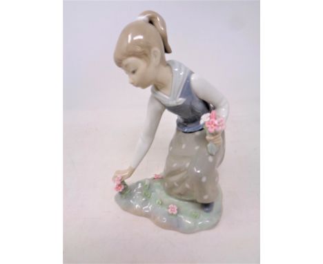 A Lladro figure, Girl picking flowers, No. 1172, together with another Lladro figure of a lady with doves 