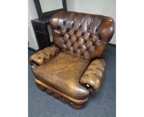 A Thomas Lloyd brown button leather manual reclining Chesterfield armchair   