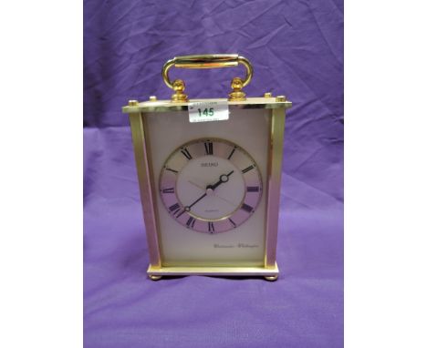 A seiko brass effect mantel clock
