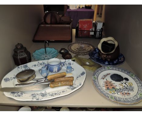 An assortment of items including midwinter bon bon dish, platter, cow bell and more.